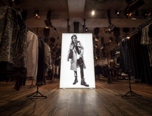All Saints shop, with a white lightbox with an image of a model in black and white printed on it
